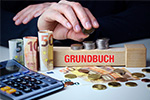 Grundbuch, Taschenrechner und Geld